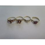 A collection of four 9ct gold rings -set with ruby and diamond, size P - red and white topaz, size N