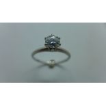 A platinum diamond solitaire ring, the 0.39ct stone held in a Tiffany Style setting over a plain