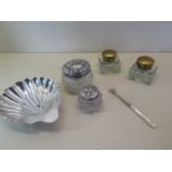 A collection of silver items, including scallop shell dish, pickle fork and two dressing table pots,