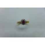 A hallmarked 18ct ruby and diamond ring, size Q, approx 4.3 grams, in good condition, minor usage