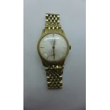 A gents 9ct gold Omega manual wristwatch on gold plate and steel bracelet, the watch with white dial