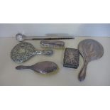 Assorted silver items to include two hand mirrors, two brushes, two photo frames, an embossed desk
