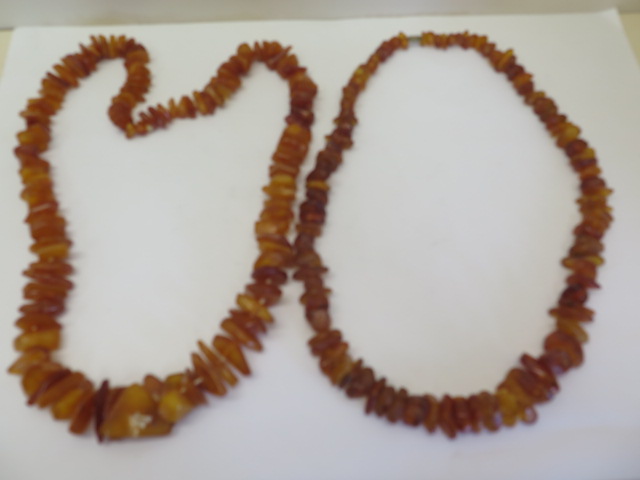 Two strings of deep honey colour un-cut polished amber beads, total weight approx 168 grams, lengths