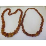 Two strings of deep honey colour un-cut polished amber beads, total weight approx 168 grams, lengths