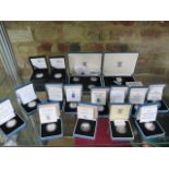 Eighteen silver proof pound coins and a collection box, 1986 to 1992, 1994,1996 to 2003 and two 2008