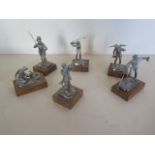 Six silver models each a character of different form including the golfer, the poacher, the