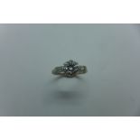 An 18ct white gold and platinum solitaire diamond ring, the centre diamond approx 1ct, flanked by