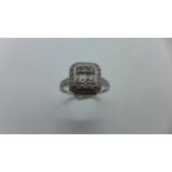 A 9ct white gold diamond octagonal cluster ring with four baguette cut diamonds and six brilliant