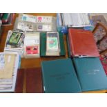 A collection of first day covers and postcards in thirteen albums and loose