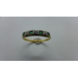 An 18ct gold diamond and emerald ring, size Q, approx 2.8 grams, marked 18ct, some marks