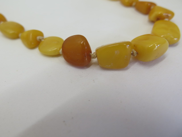 Two strings of natural polished amber beads, deep honey and egg yolk colours, larger string 74cm - Image 3 of 4