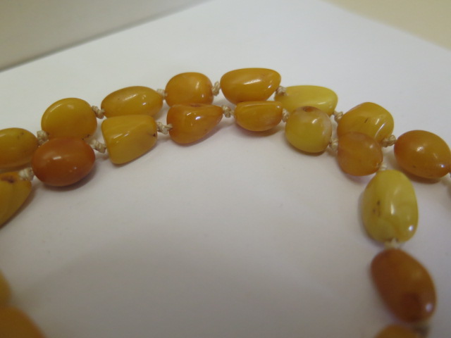 Two strings of natural polished amber beads, deep honey and egg yolk colours, larger string 74cm - Image 4 of 4