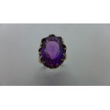 A large gold and amethyst dress ring, stone measures approx 18x13mm, ring size P, not hallmarked but