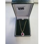 An 18ct yellow gold ruby and diamond pendant and snake link chain, the pendant measuring 13x11mm,
