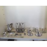 A good collection of silver plate including a good quality cruet set, five night sticks, toast