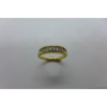 An 18ct hallmarked gold diamond ring, size P, set with five diamonds, approx 5.3 grams, in good