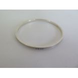 A silver Tiffany and Co bangle, 6.5cm diameter, some marks consistent with use otherwise good