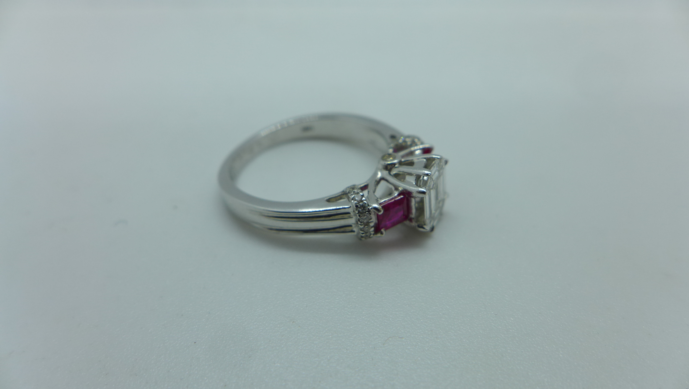 An 18ct white gold diamond and ruby ring with a centre 9 piece diamond, emerald cut measuring 7mm - Image 3 of 4