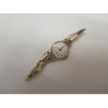 A 9ct gold ladies record manual wind wristwatch on a gold plated strap, running, approx 16gs