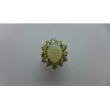 An impressive 14ct gold opal and diamond ring - the central opal approx 12.5mm x 9mm x 3.5mm