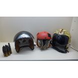 A Gentex flying helmet with Tiger decoration, a flight desk crew helmet and earphones and a