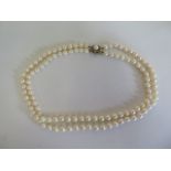 A double string of pearls, 40cm long with a hallmarked 9ct clasp, pearls approx 5mm, in generally