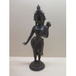 A bronze Hindu figure of a female deity 43cm tall with good patination, hole has been drilled to