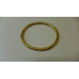 A 9ct yellow gold hinged bangle marked 375 - 6.5cm x 6cm - approx weight 22.8 grams - slight