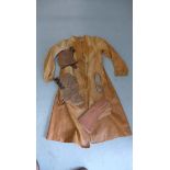 A soft light tan leather flying coat, 2 leather flying helmets, a pair of goggles and gauntlets. All