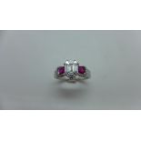 An 18ct white gold diamond and ruby ring with a centre 9 piece diamond, emerald cut measuring 7mm