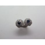 A pair of 18ct white gold sapphire and diamond swirl earrings, 10mm diameter, in good condition,