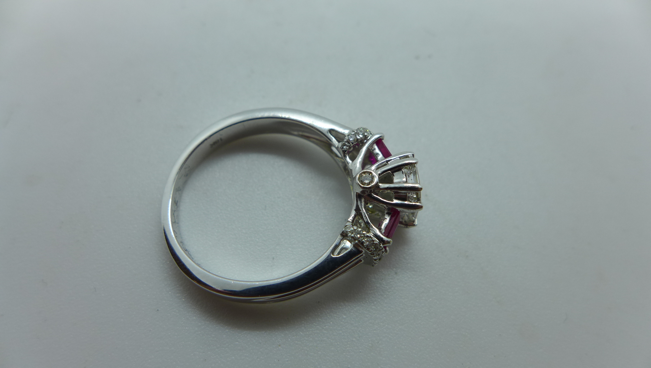 An 18ct white gold diamond and ruby ring with a centre 9 piece diamond, emerald cut measuring 7mm - Image 4 of 4