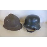 A WWII French helmet missing badge and a post war German helmet