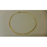 An 18ct yellow and white gold reversible necklace marked 750 - approx weight 16.5 grams - in