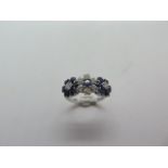 A hallmarked 18ct white gold diamond and sapphire triple cluster ring, size L, approx 3.5 grams,