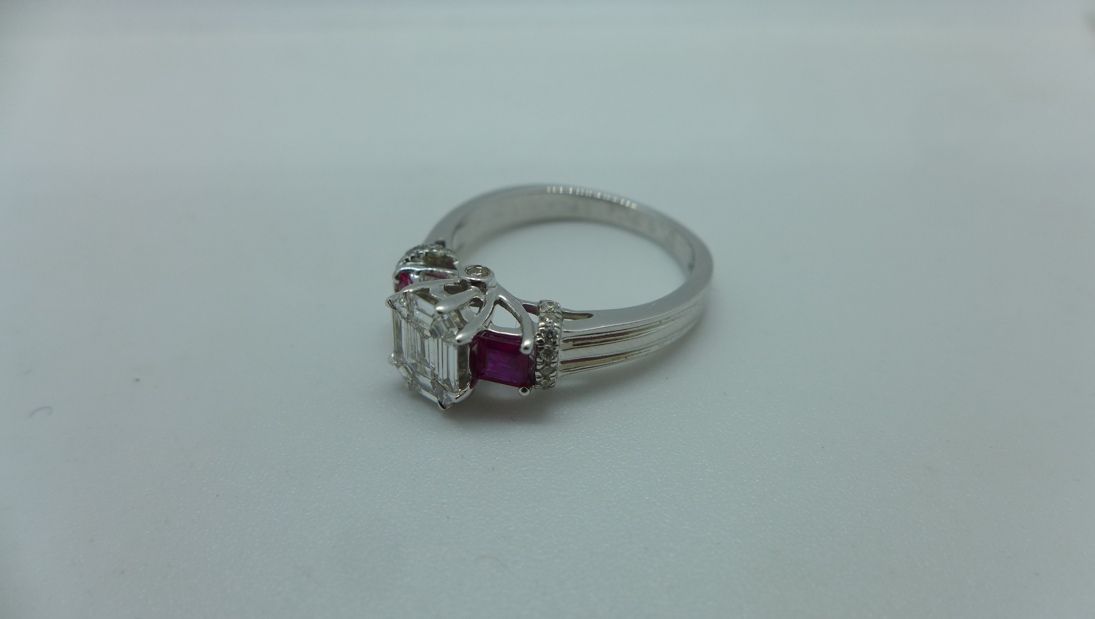 An 18ct white gold diamond and ruby ring with a centre 9 piece diamond, emerald cut measuring 7mm - Image 2 of 4