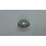 An 18ct white gold (tested) Art Deco old cut diamond bombe ring - centre stone approx 0.9ct - no