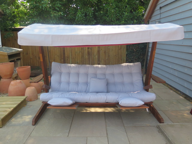 A very good quality Swingroo Iroko swinging hammock with a grey canopy and seat pads