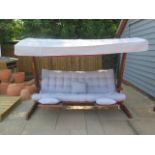 A very good quality Swingroo Iroko swinging hammock with a grey canopy and seat pads