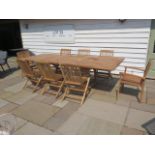 A new boxed teak garden table with 2 armchairs and 6 folding chairs with 2 foldout leaves, extends