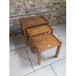 A nest of 3 hardwood garden tables