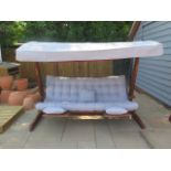 A very good quality Swingroo Iroko swinging hammock with a grey canopy and seat pads