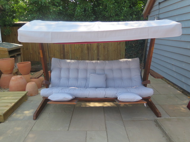 A very good quality Swingroo Iroko swinging hammock with a grey canopy and seat pads