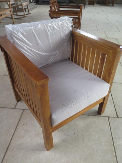 A pair of hardwood garden chairs with cushions