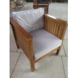 A pair of hardwood garden chairs with cushions