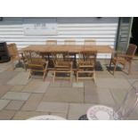 A new boxed teak garden table with 2 armchairs and 6 folding chairs with 2 foldout leaves, extends