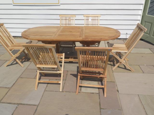 A new boxed teak garden table & 6 folding chairs. Table size extends from 150cm to 200cm with a 90cm