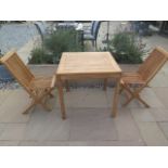 A new boxed teak bistro table 70cm x 70cm and two folding dining chairs.