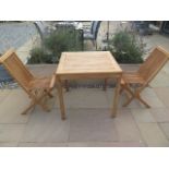 A new boxed teak bistro table 70cm x 70cm and two folding dining chairs.