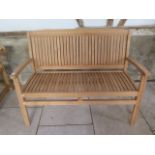 A teak garden bench 120cm wide